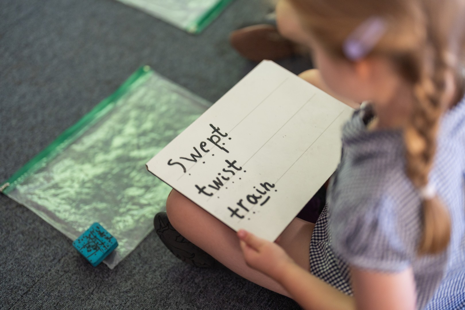 Child's phonics whiteboard containing writing 