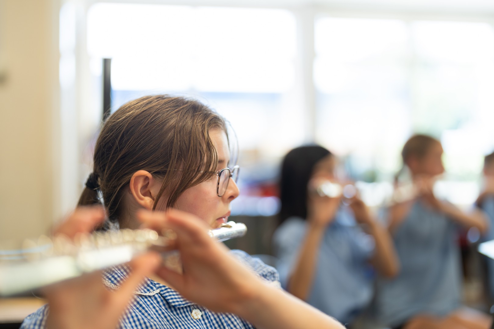 Music Children playing the flute in an orchestra