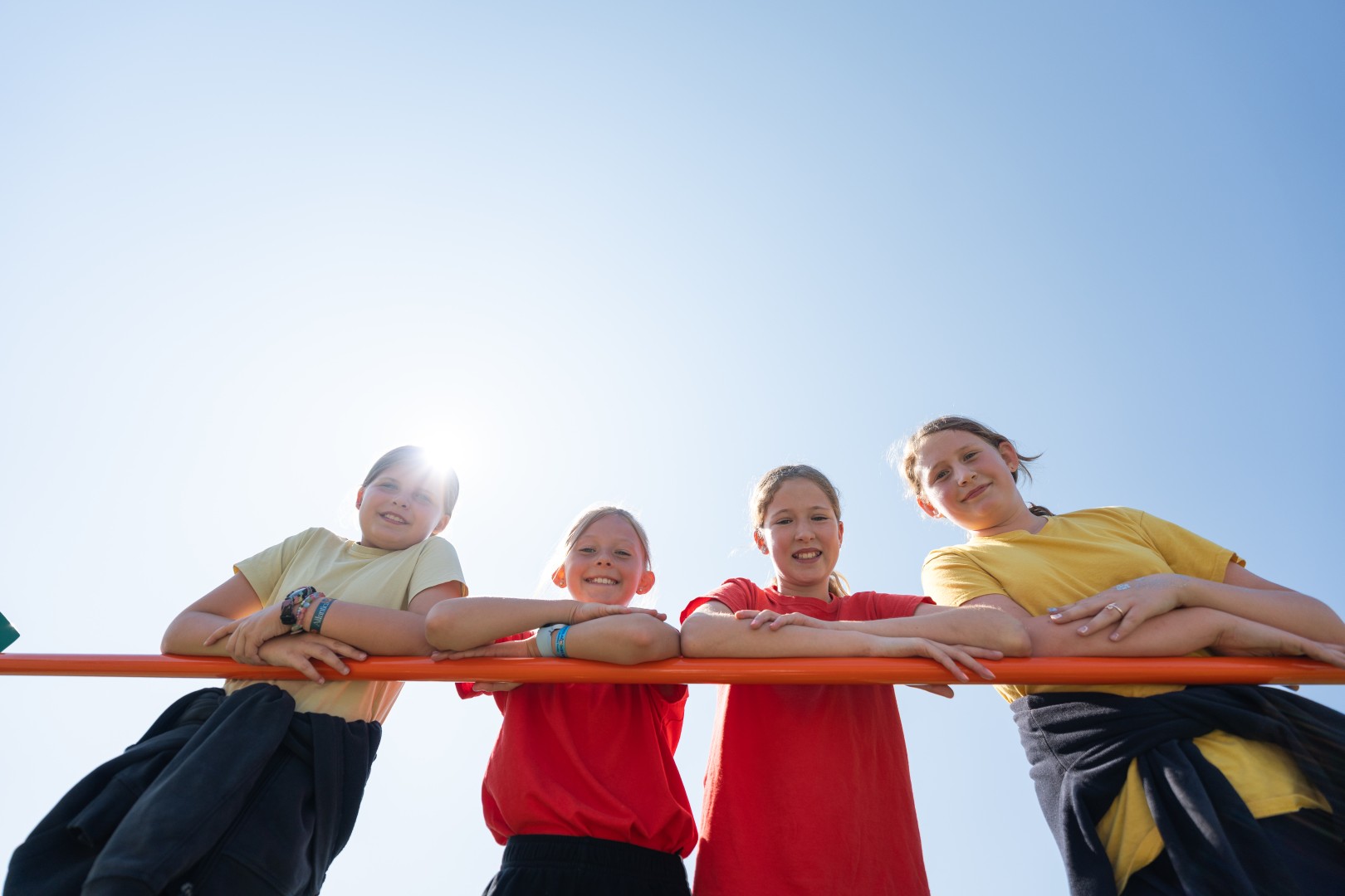 Four smiling children in the sunshine